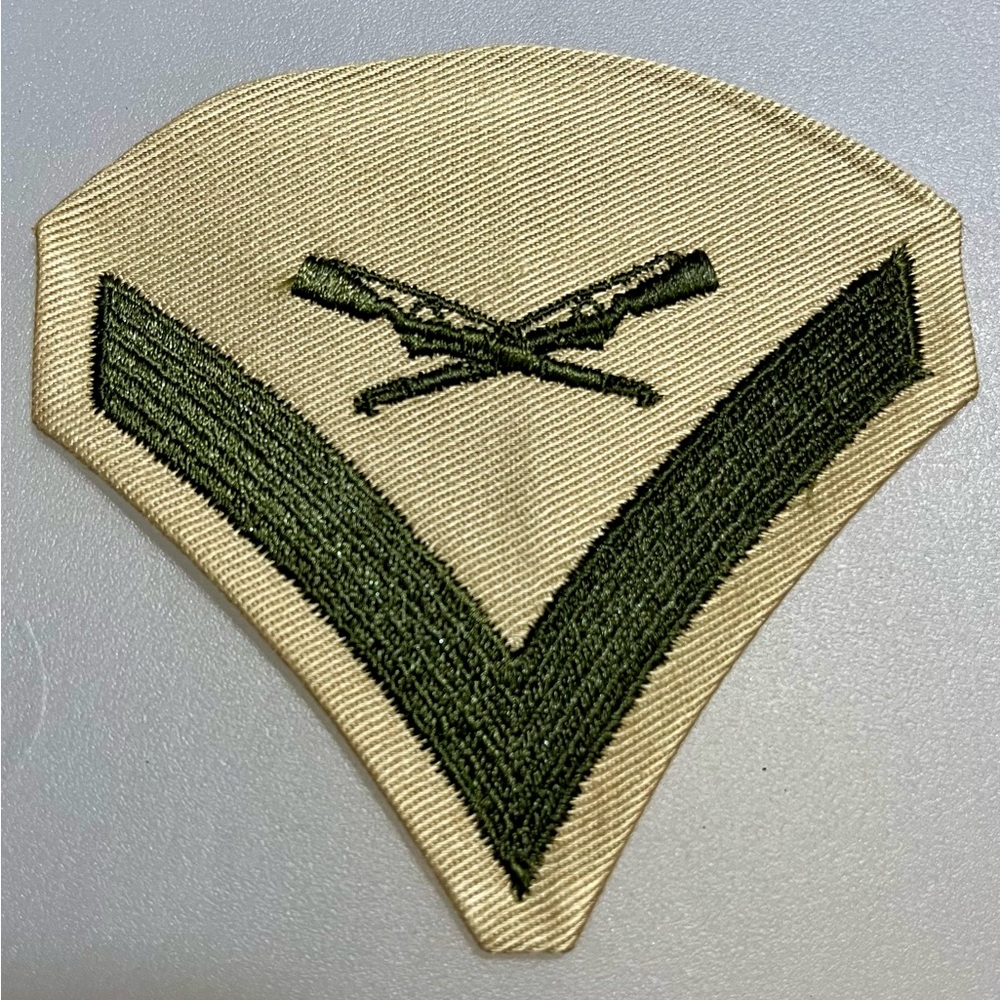 Vintage US Marine Corps green on khaki Lance Corporal rank Chevron insignia.